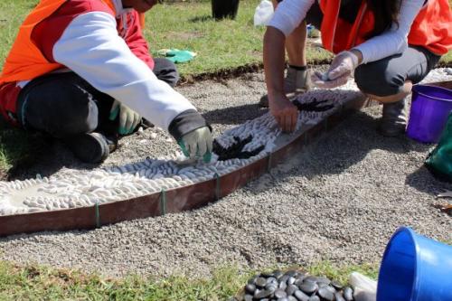 Two young people laying peddles into a mosaic for a project in Barwon South west Region